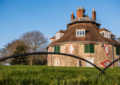 Historic building called Al la Ronde, in Exmouth. Blue sky and green grass